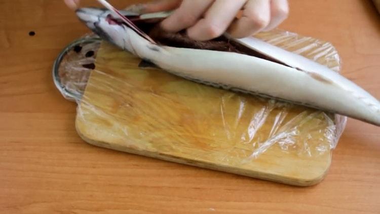 To cook mackerel with vegetables in the oven, clean the fish