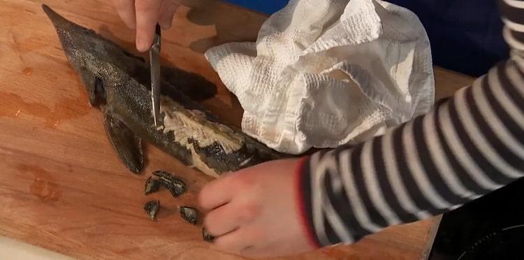 To prepare the sterlet fish soup, clean the fish
