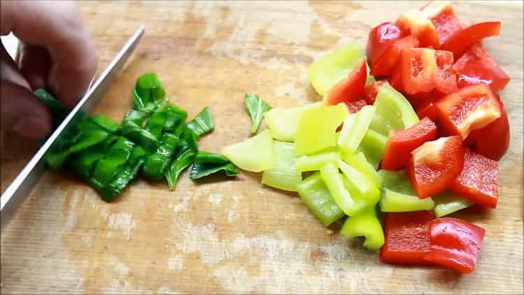 To prepare the pike perch fillet in the oven, chop the basil