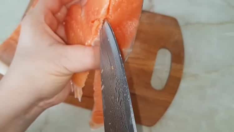 To prepare slightly salted trout, cut the fish