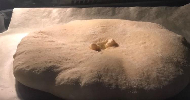 We send the pan with khachapuri to the oven.