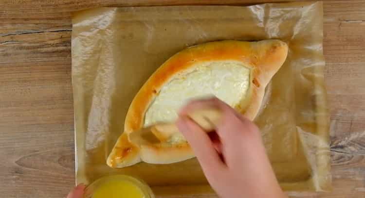 To prepare a khachapuri boat, preheat the oven