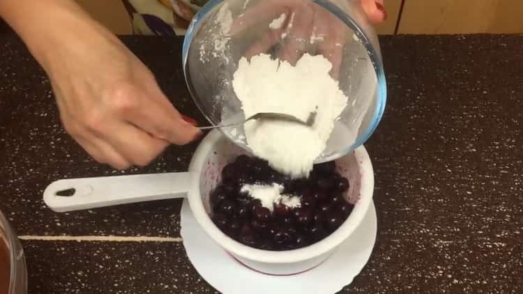 To make a chocolate muffin with cherry, sprinkle the cherry with flour