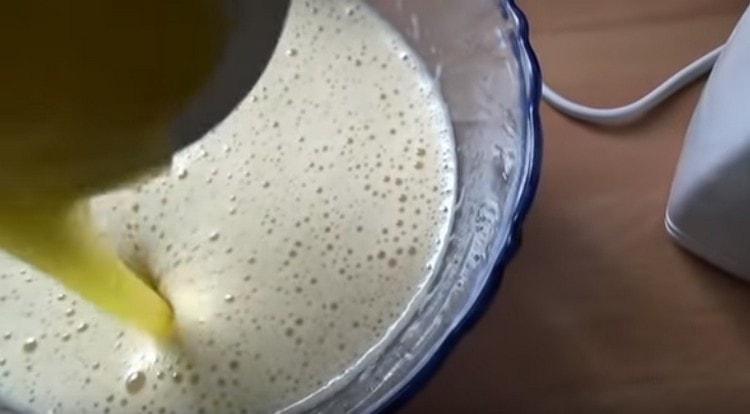 Add melted butter to the egg mass.