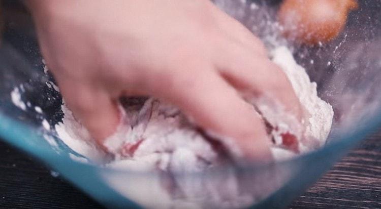 roll pieces of meat in flour.