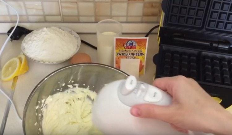 Beat butter with sugar with a mixer.