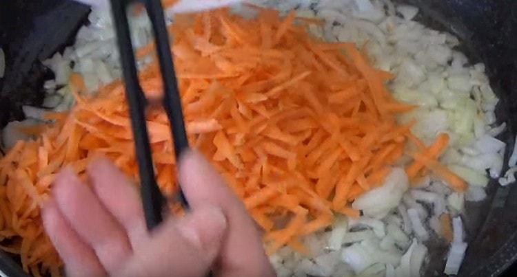 Add carrots to the onion.