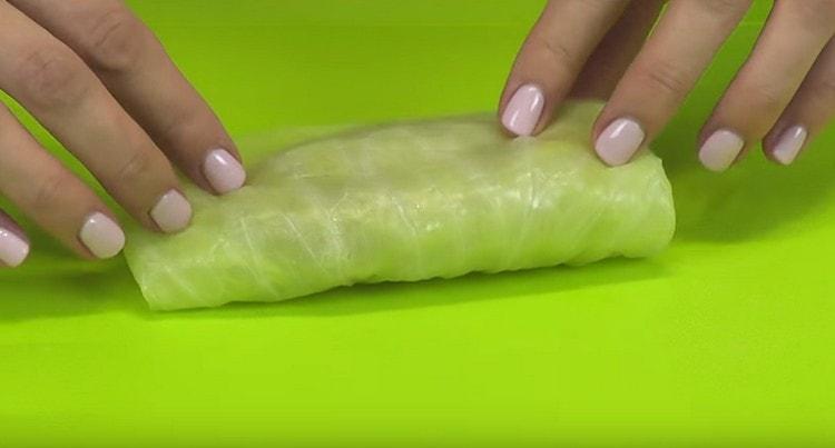 Wrap about a spoonful of minced meat in soft cabbage leaves.