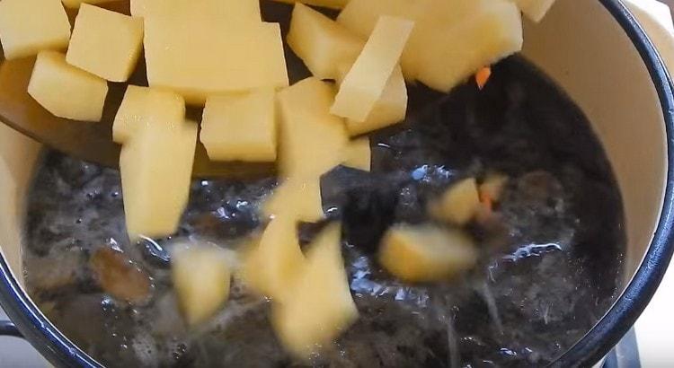 Add the sliced ​​potatoes to the mushrooms.