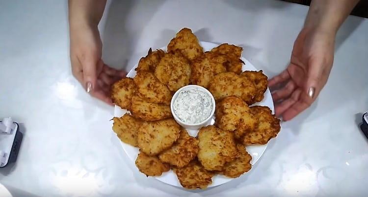 Draniki with minced meat perfectly complement sour cream sauce.