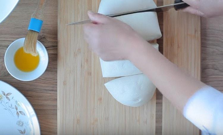 After 15 minutes, divide the dough into 4 parts.