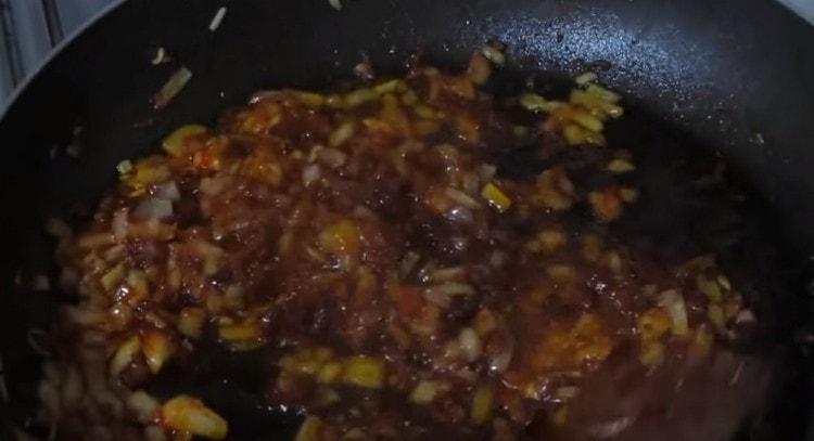 Fry onion with tomato paste.