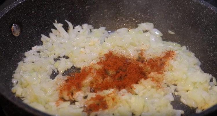 Add paprika to the onion with garlic.