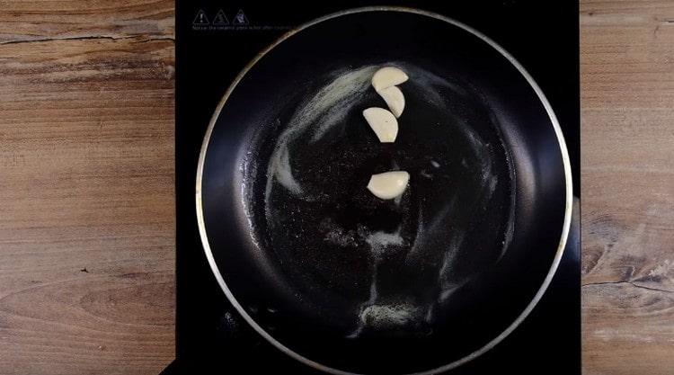 Put a few cloves of garlic in the oil.