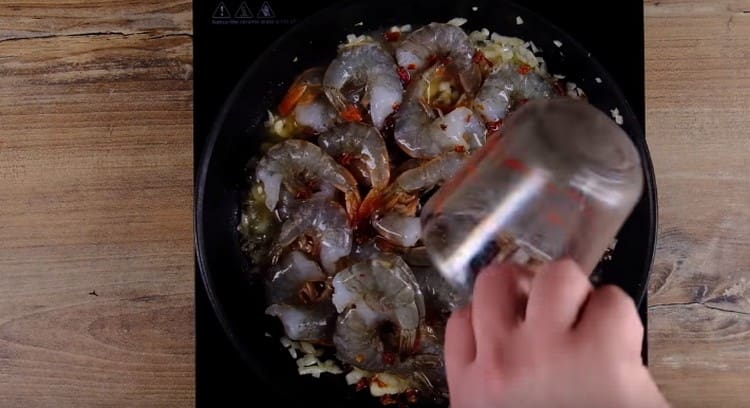 Add white dry wine and lemon juice to the seafood pan.