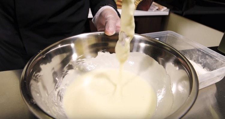 After flour, roll the shrimp in batter.