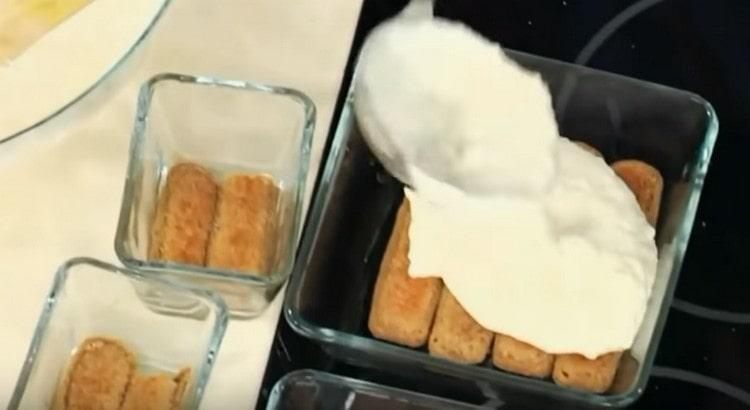 Dip the Savoyardi cookies in coffee with cognac, put in tins, and cover with cream on top.