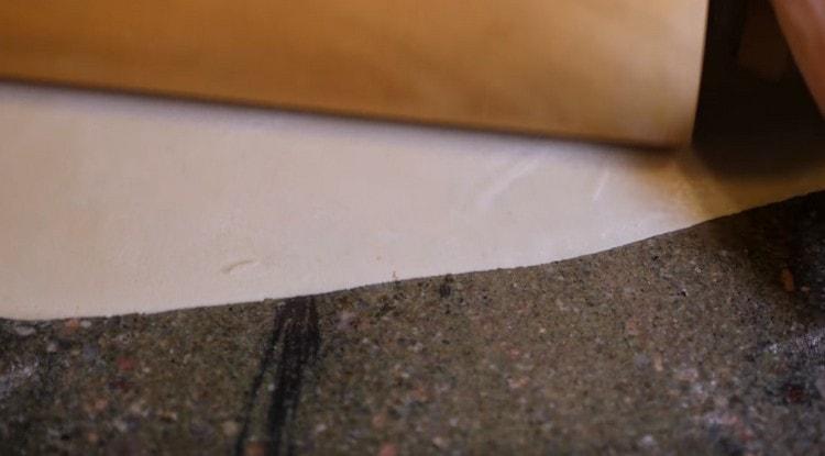 Roll out the dough into a very thin layer.