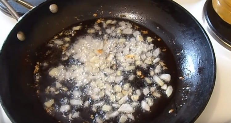 Fry chopped onions in a pan.