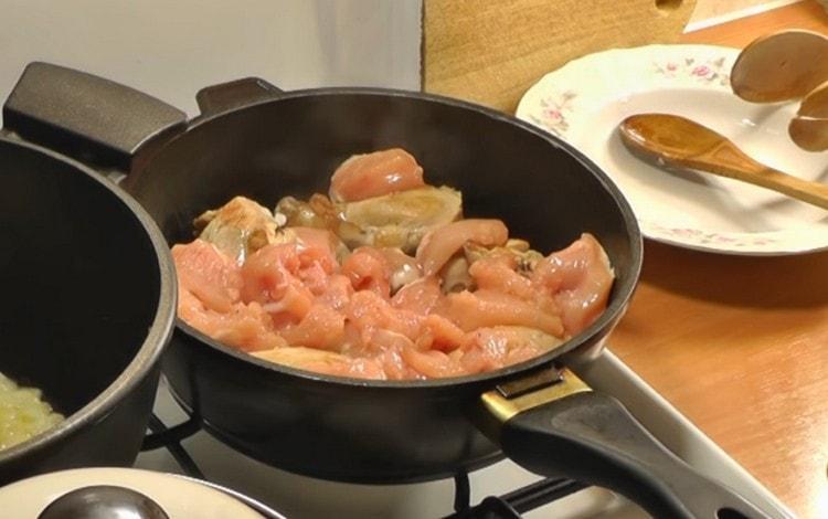 In another pan, fry the chicken pieces.