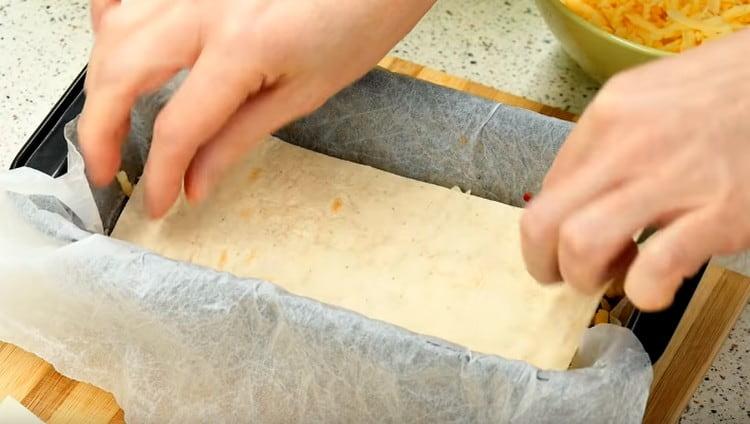 Cover the cheese layer with pita bread and repeat the layers.