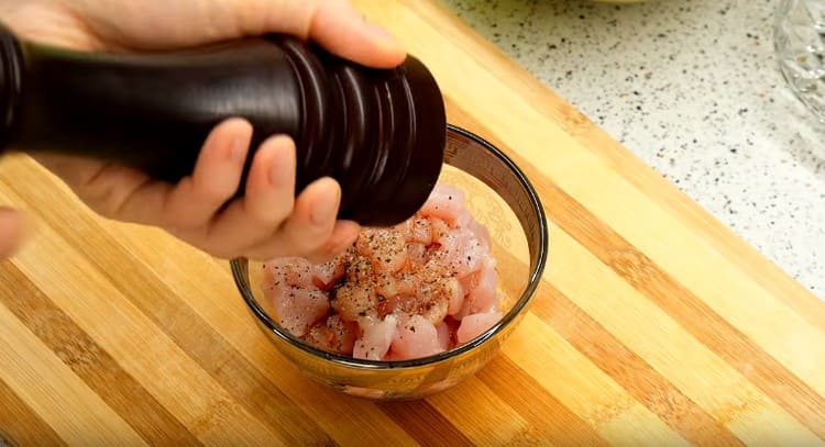 Salt and pepper pieces of chicken.