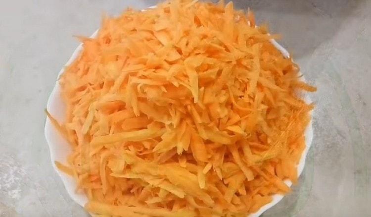 Three carrots on a grater.