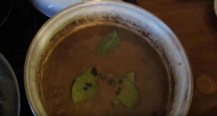 Add peas and bay leaves to the dish.