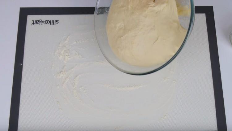 We shift the approached dough onto a surface sprinkled with flour.