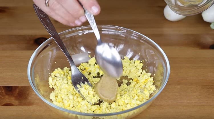 Rub the egg yolks with mustard.
