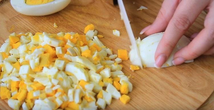 Dice hard-boiled eggs.