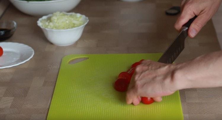 Cherry tomatoes are cut in half.