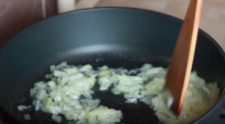 First, fry the chopped onions.