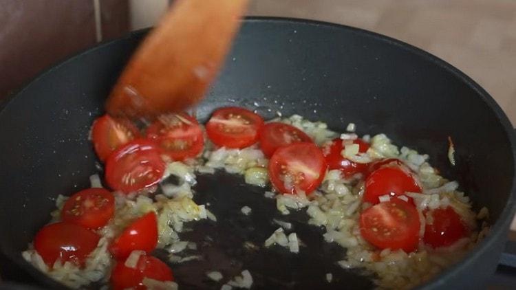 Add tomatoes to the onion.