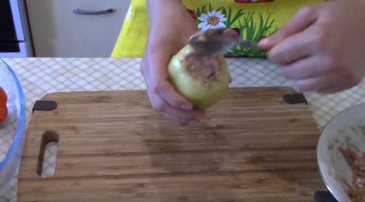 We stuff the peppers with the filling.