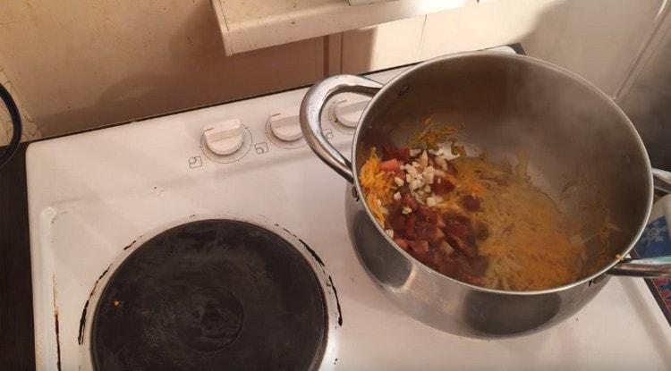 Next, add the tomatoes and garlic.