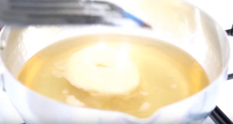 Put the donuts in boiling oil.