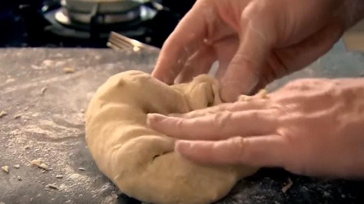 We spread the dough on the table and knead it with your hands.