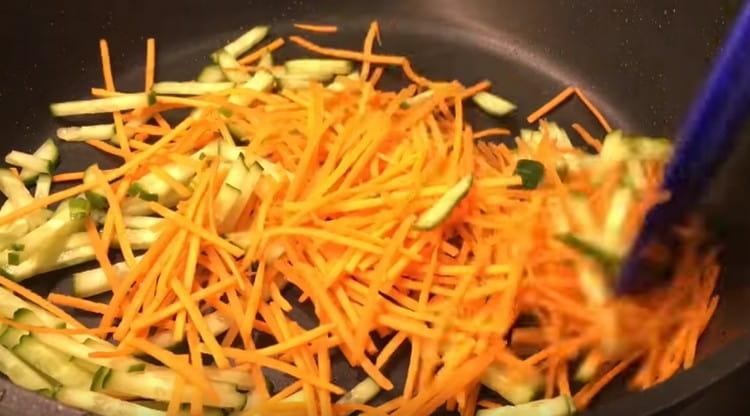 Add the cucumber, cut into strips, to the carrots and fry the vegetables together
