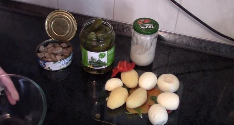 Boil potatoes and eggs until cooked and peel.