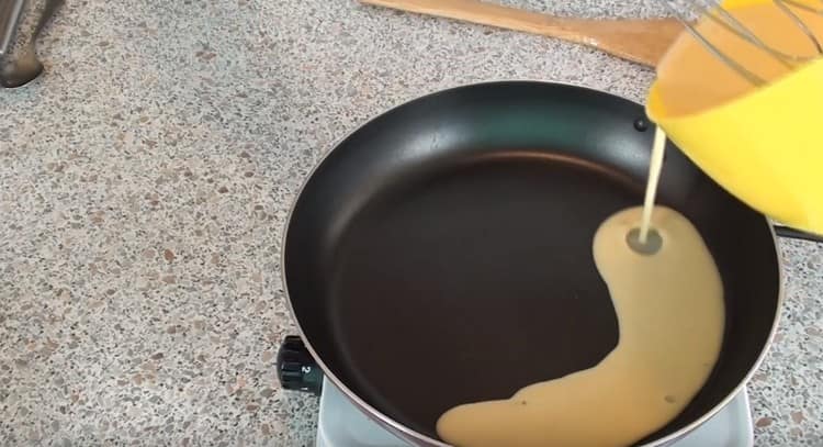 pour the dough in portions into a hot pan, forming thin pancakes.