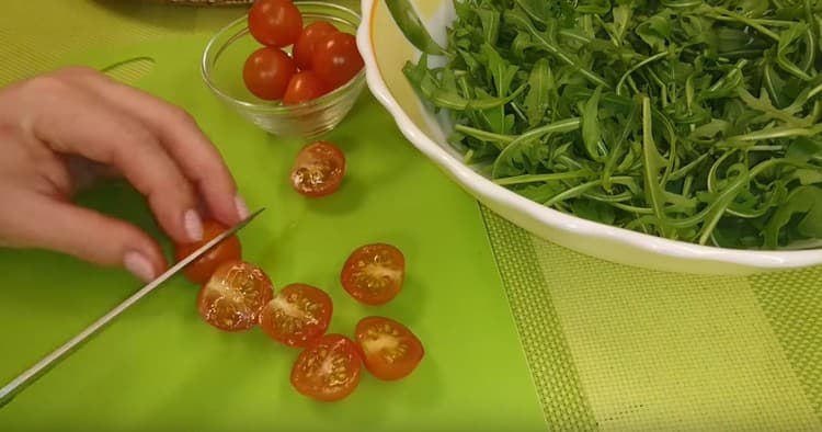 Cherry tomatoes are cut in half.