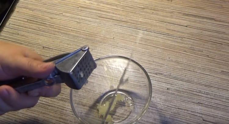 Squeeze the garlic into a bowl.