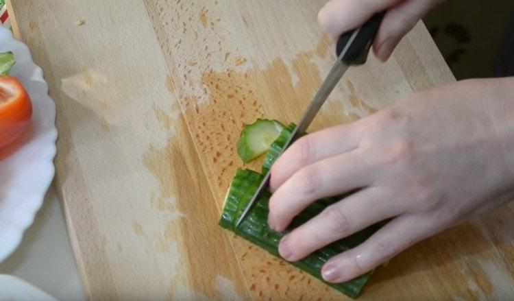 We also cut cucumbers and tomatoes into pieces.