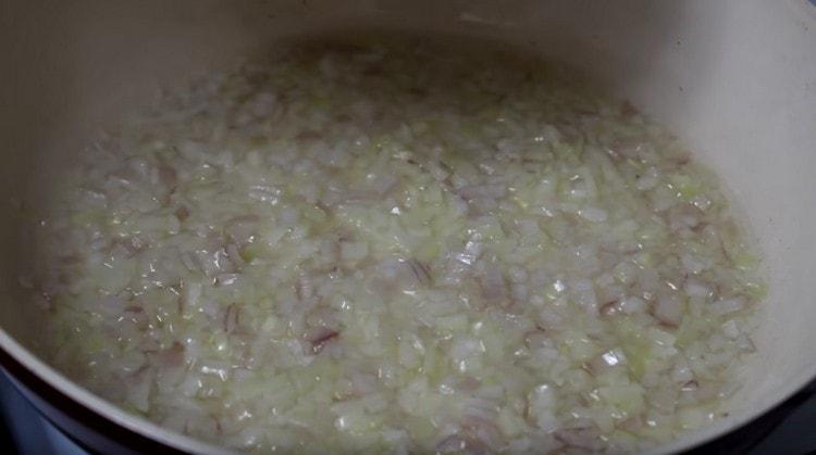 Fry the onions in a pan until soft.