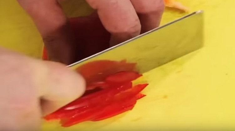 Straws cut red bell pepper.