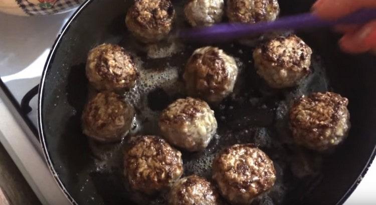 Fry meatballs until golden brown.