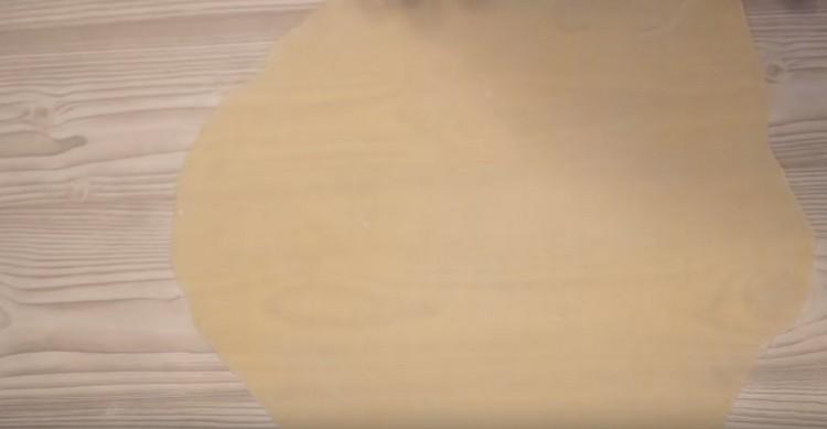 Roll each portion of the dough into a thin cake.