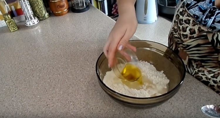 We make a depression in the flour and pour water and vegetable oil into it.
