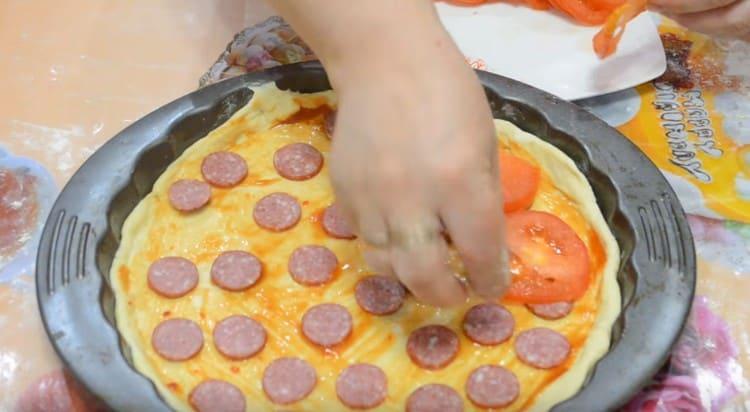 Put tomatoes on top of the sausage.